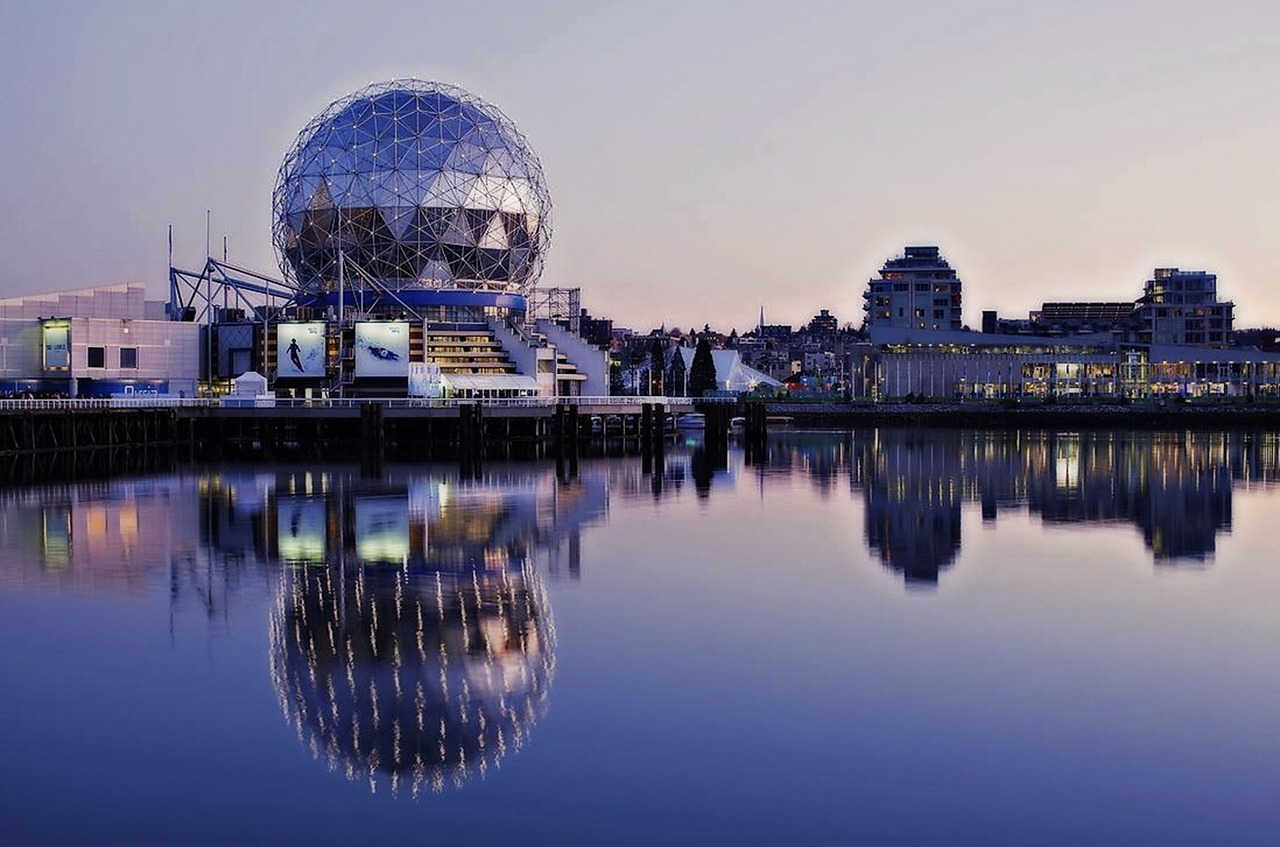 science-world-false-creek-vancouver-210775 View of Science World at False Creek, Vancouver, with its iconic geodesic dome and colorful exterior against a cloudy sky.